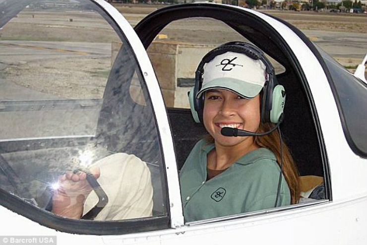 Looking up: Jessica poses with flight instructor Parrish Traweek while on the way to becoming a pilot 