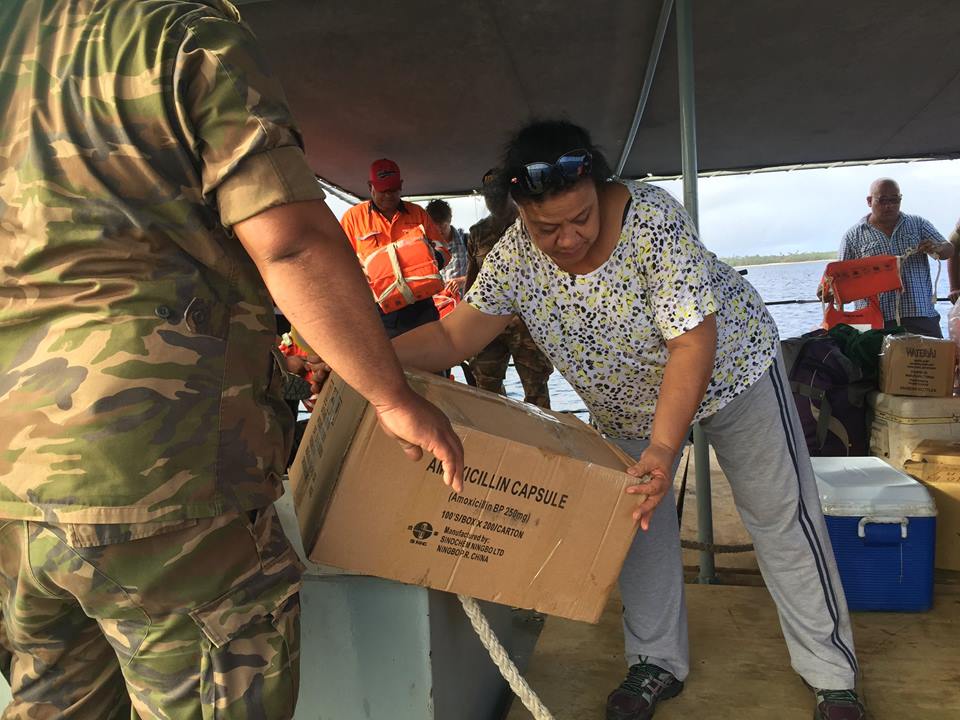 Dr. Toa Fakakovikaetau and Tonga Navy load the load medical supplies for the outer islands visit.