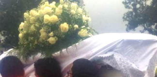 Co-workers and friends carry the coffin of Herman Topui