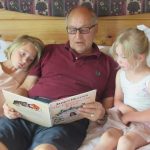 Canadian Jack Saprunoff reading to grandchildren Ivy and Zosia Costello Photo Supplied RNZ
