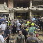 people-gather-near-a-damaged-building-at-the-scene-of-an-isr-CSER36VXMFE23KZFPSQ7BKJHPM copy