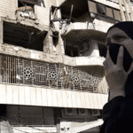 a-woman-reacts-in-front-an-apartment-in-a-multistory-buildin-EJOPXE6EX5GT5NCG5OAN6E677A copy