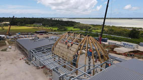 Tonga’s new Parliament rises above foundations as sweeping timber roof takes shape